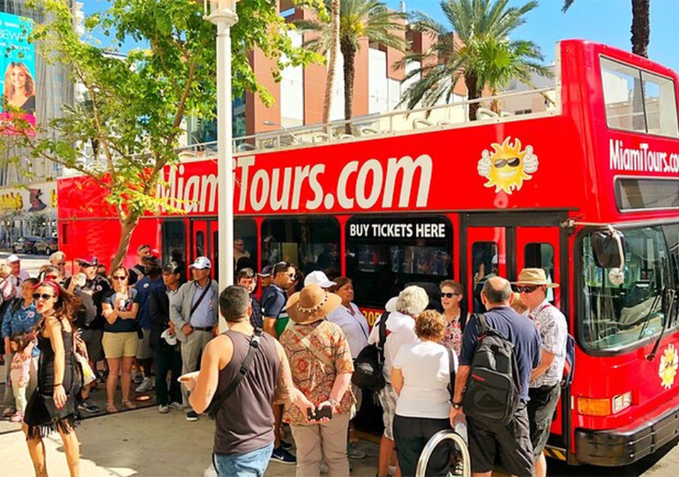 Picture of a group in front of the double decker bus for the Miami City Tour provided by Miami G